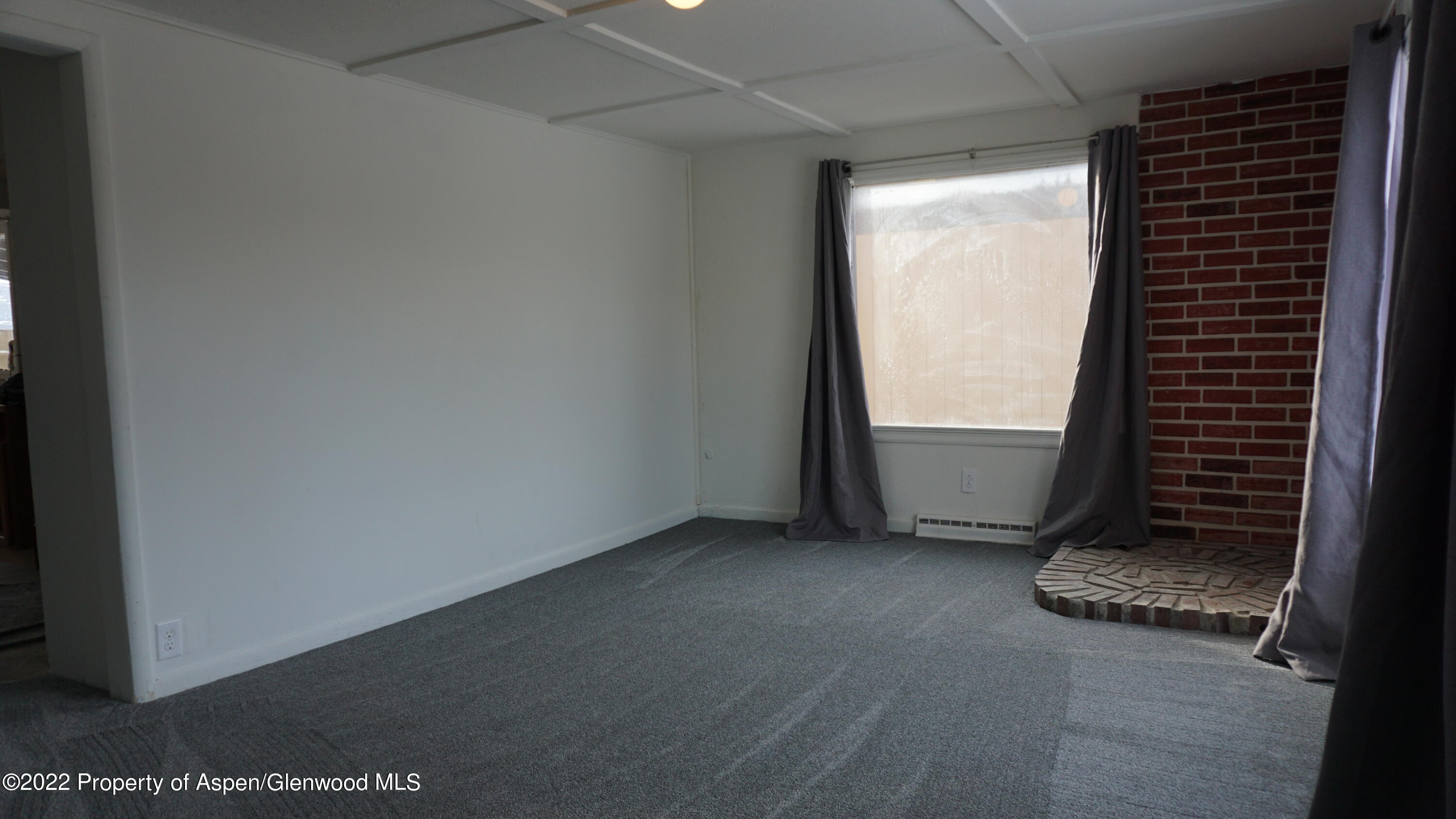 427 East 11th Street Rifle, CO 81650 - Photo 4 of 23 an empty room with windows