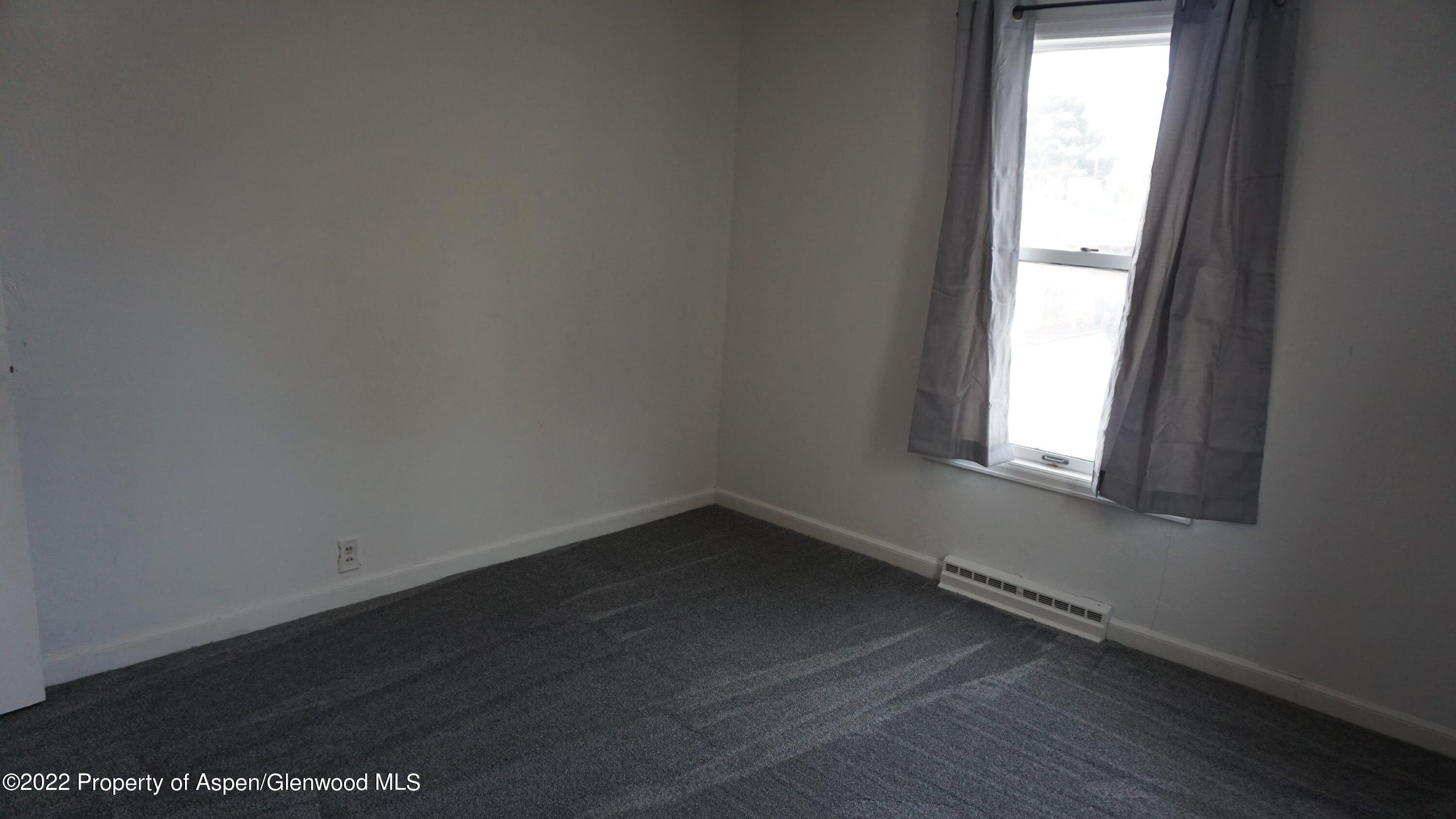427 East 11th Street Rifle, CO 81650 - Photo 10 of 23 an empty room with a window
