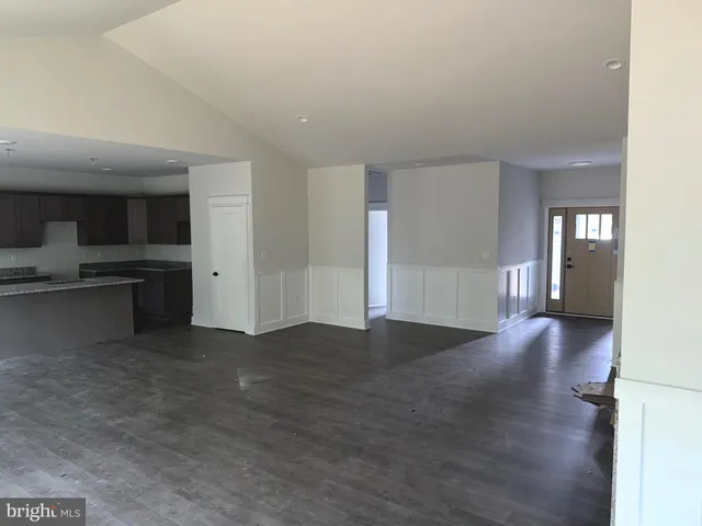a kitchen that has a sink a stove and a refrigerator