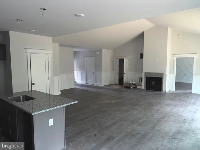 an empty room with wooden floor and cabinet