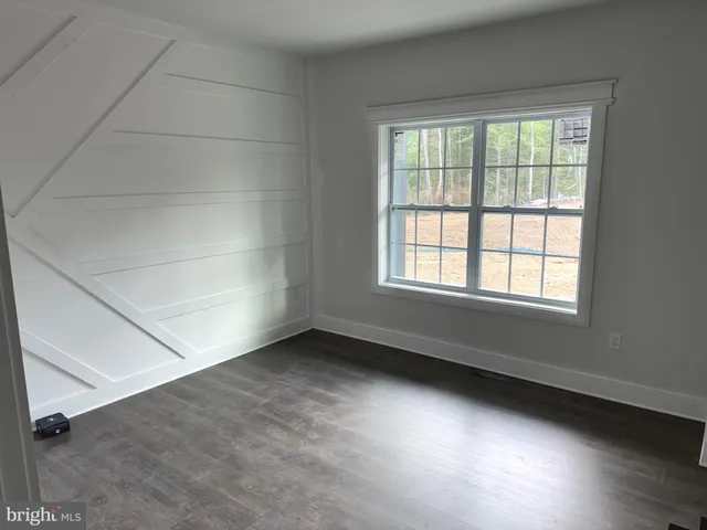 an empty room with wooden floor