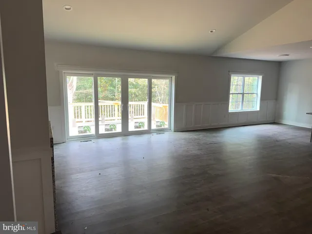 an empty room with a bathroom and a window