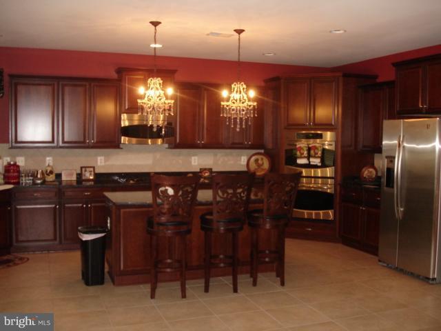 6554 Pebble Brooke Road Baltimore, MD 21209 - Photo 1 of 17 a kitchen with stainless steel appliances granite countertop a sink a stove and a refrigerator