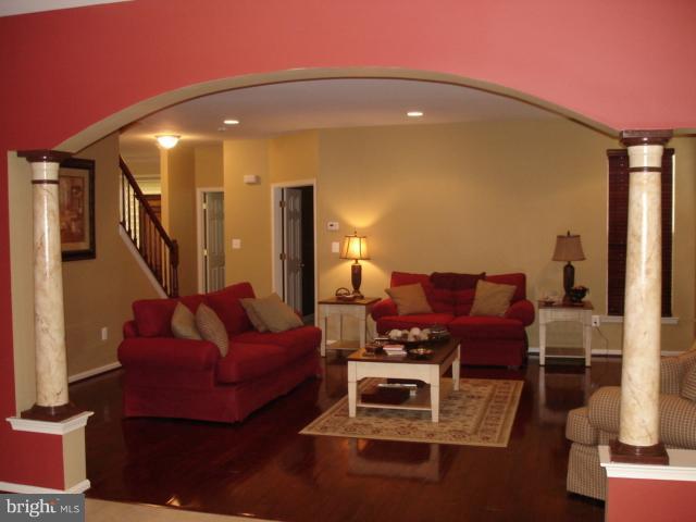 6554 Pebble Brooke Road Baltimore, MD 21209 - Photo 12 of 17 a living room with furniture and a potted plant