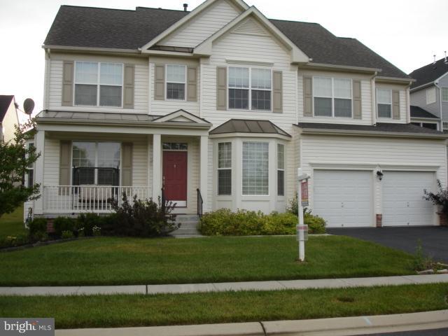 6554 Pebble Brooke Road Baltimore, MD 21209 - Photo 17 of 17 a front view of a house with a yard