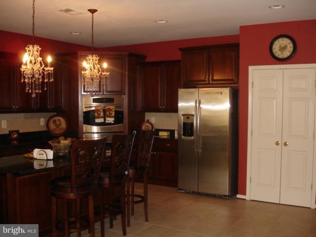 6554 Pebble Brooke Road Baltimore, MD 21209 - Photo 5 of 17 a kitchen with refrigerator and window