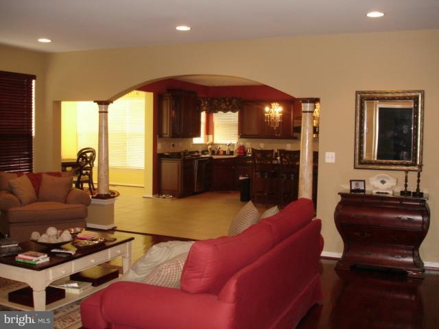 6554 Pebble Brooke Road Baltimore, MD 21209 - Photo 6 of 17 a living room with furniture and a flat screen tv