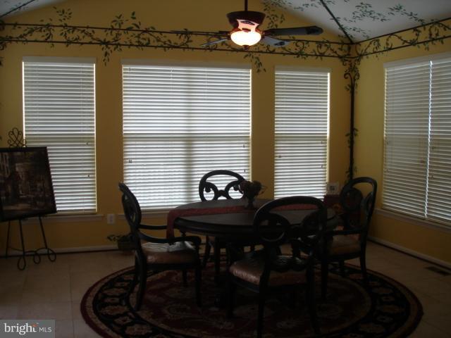 6554 Pebble Brooke Road Baltimore, MD 21209 - Photo 7 of 17 a view of a dining room with furniture and chandelier