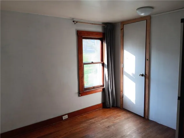 a white toilet sitting next to a window in a bathroom