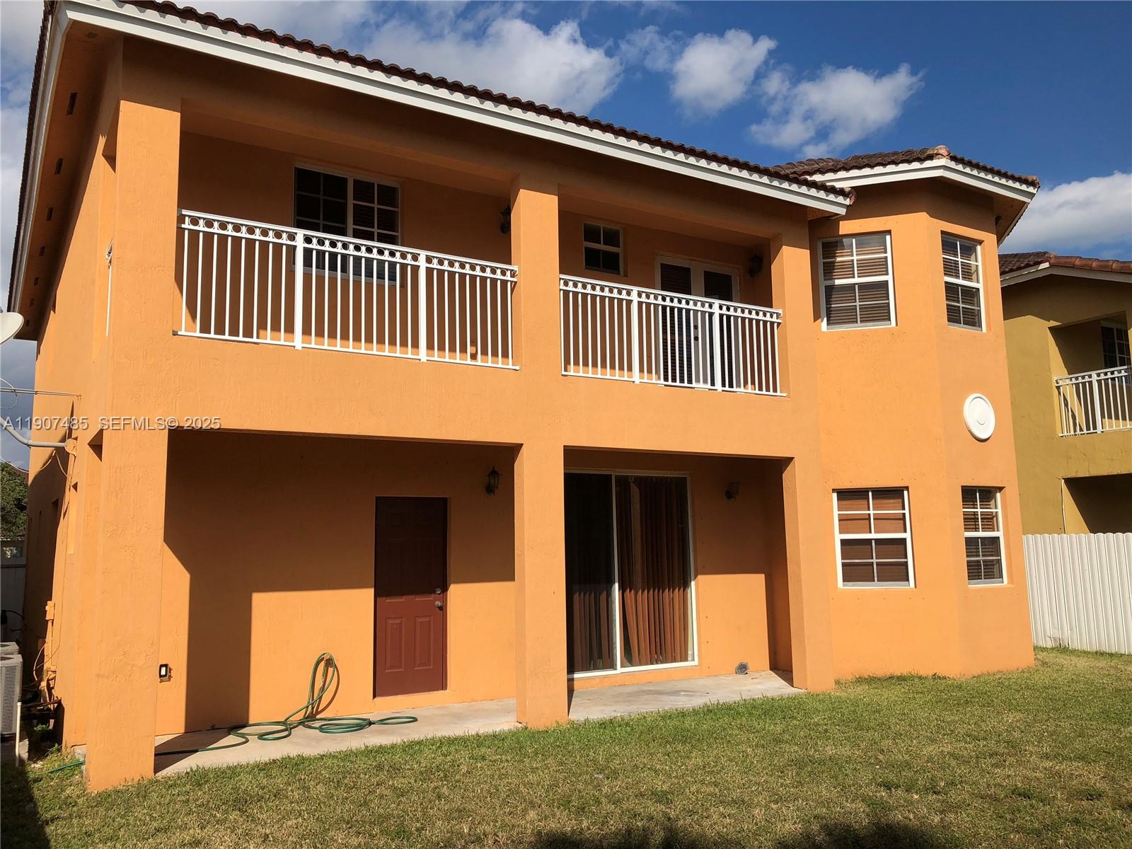 13426 Southwest 177th Terrace Miami, FL 33177 - Photo 13 of 36 a front view of a house with a yard