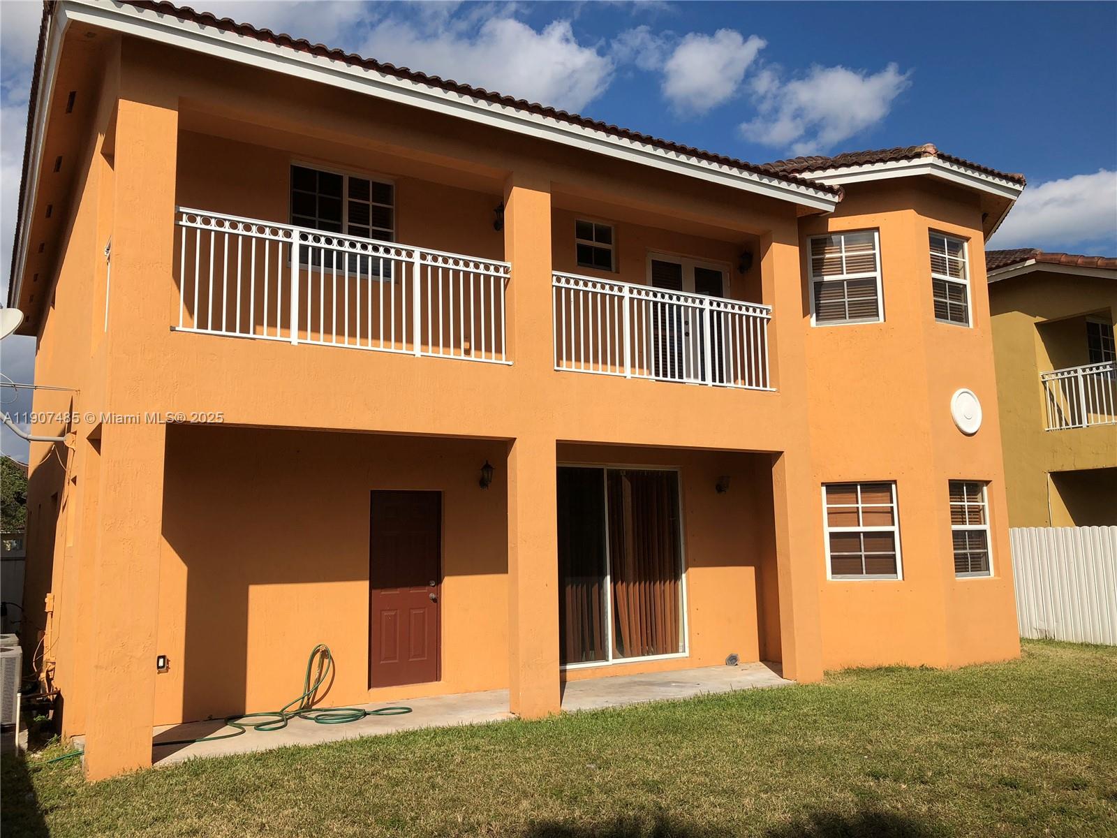 13426 Southwest 177th Terrace Miami, FL 33177 - Photo 13 of 36 a front view of a house with a yard