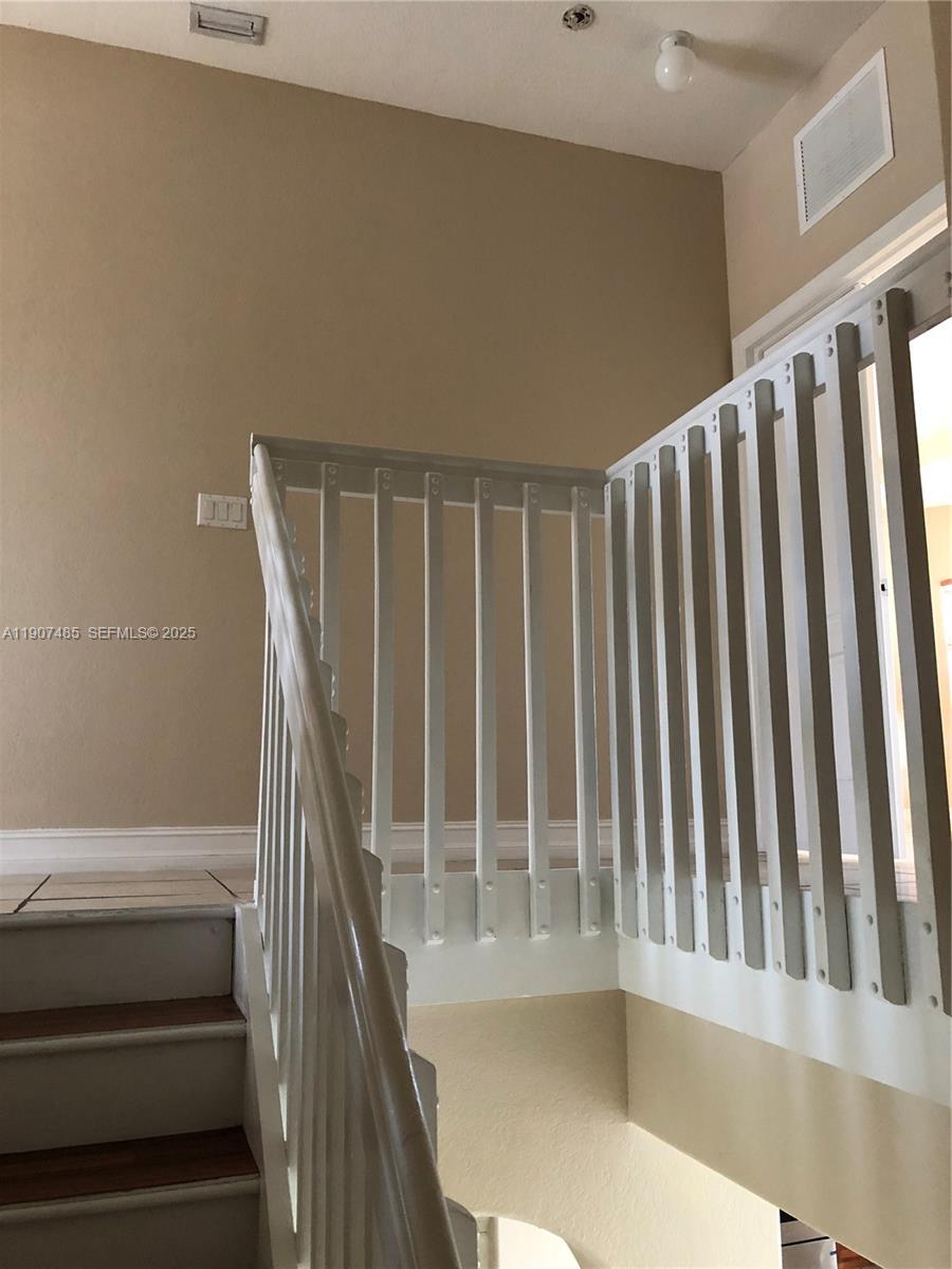 13426 Southwest 177th Terrace Miami, FL 33177 - Photo 18 of 36 a view of staircase with railing and white walls