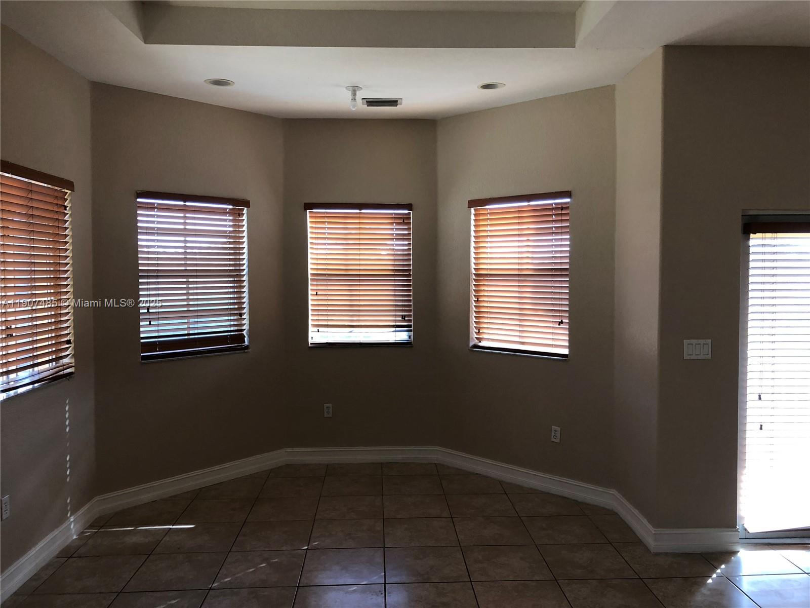 13426 Southwest 177th Terrace Miami, FL 33177 - Photo 25 of 36 a view of an empty room with a window
