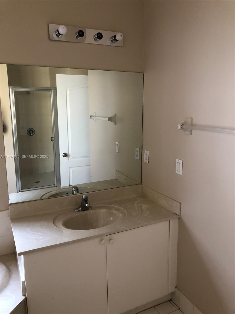 13426 Southwest 177th Terrace Miami, FL 33177 - Photo 30 of 36 a bathroom with a sink and a mirror