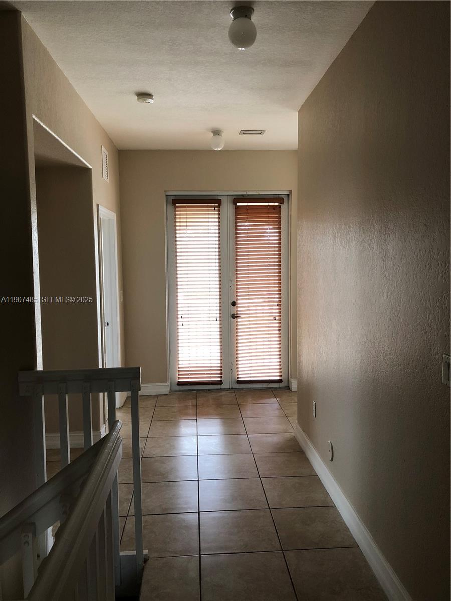 13426 Southwest 177th Terrace Miami, FL 33177 - Photo 31 of 36 a view of an empty room with a window