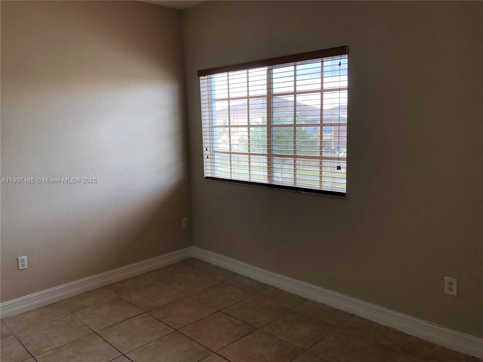 13426 Southwest 177th Terrace Miami, FL 33177 - Photo 33 of 36 an empty room with a window