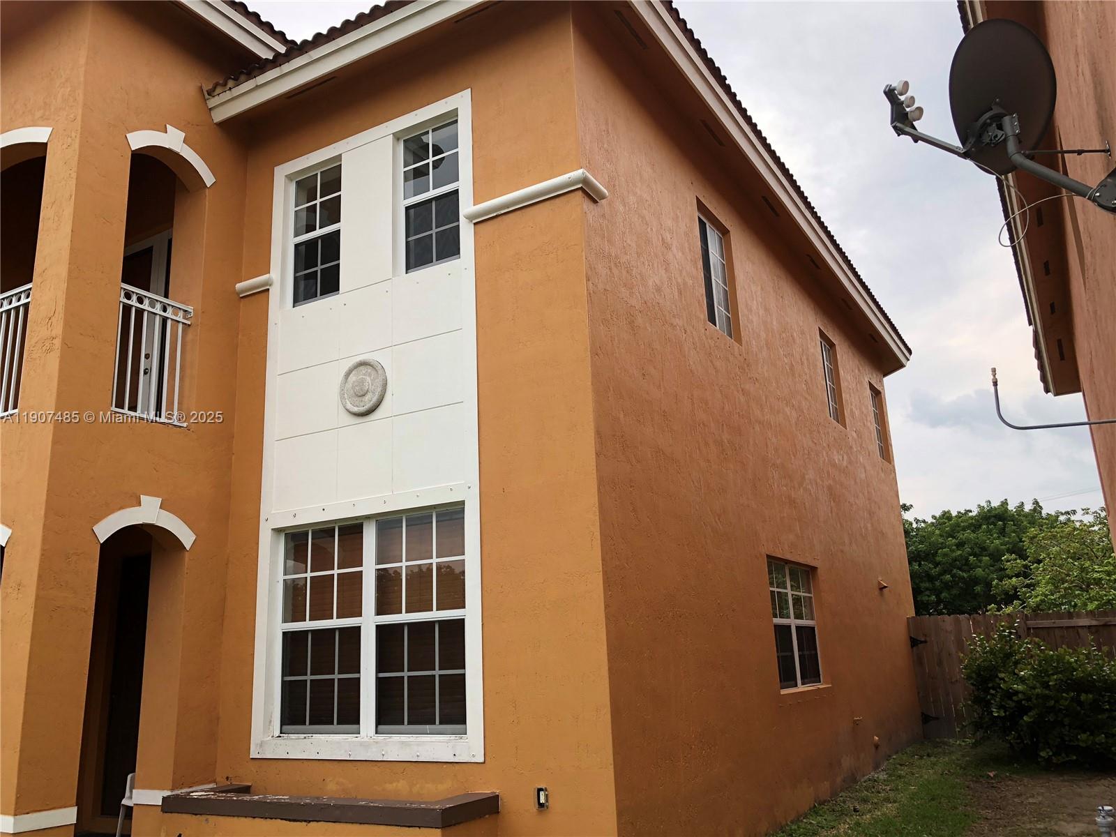 13426 Southwest 177th Terrace Miami, FL 33177 - Photo 6 of 36 a front view of a house with a yard