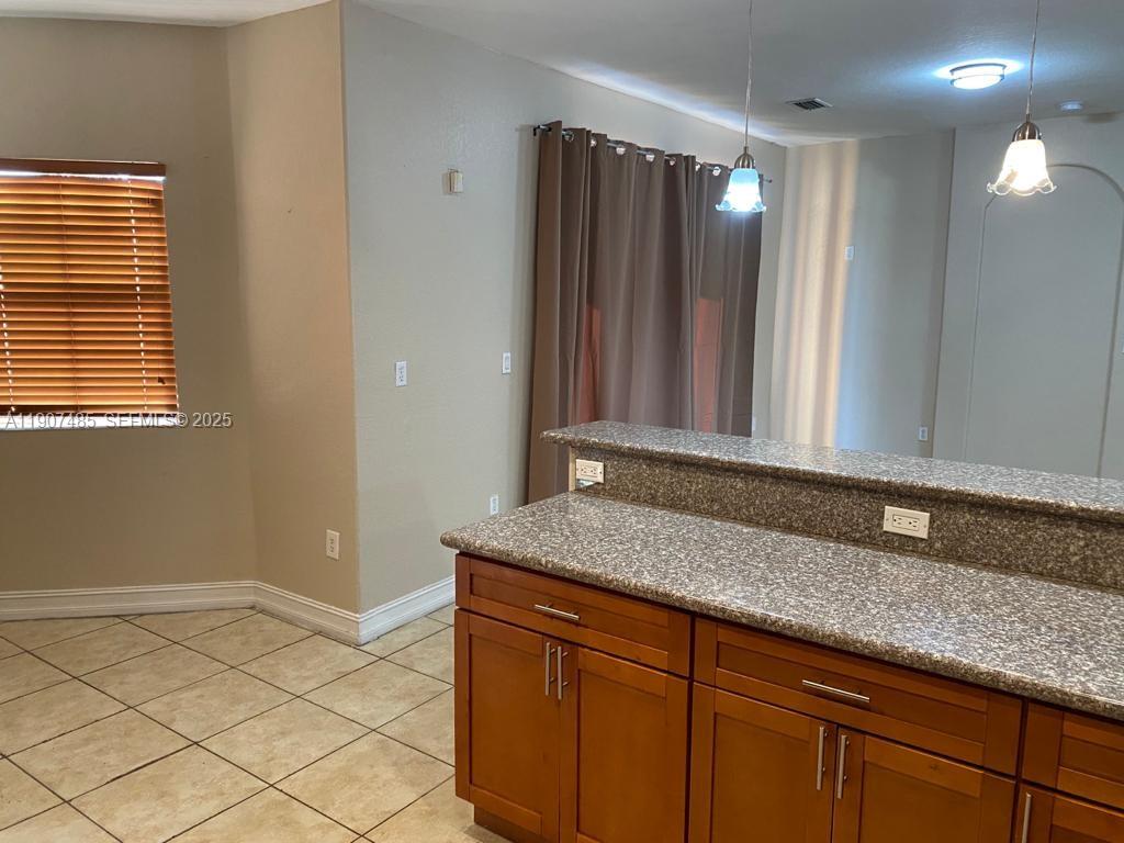 13426 Southwest 177th Terrace Miami, FL 33177 - Photo 9 of 36 a bathroom with a granite countertop sink and a mirror