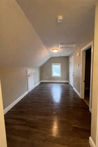 a view of wooden floor and windows in a room
