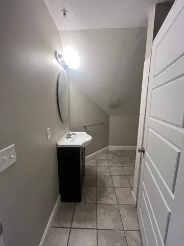 a bathroom with a sink a vanity and a mirror