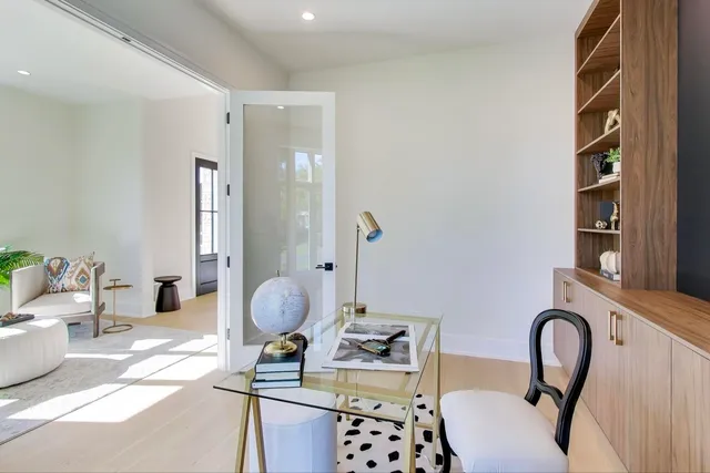 a kitchen with stainless steel appliances granite countertop a sink a stove and a wooden floors
