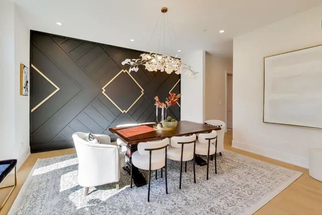 a kitchen with stainless steel appliances kitchen island a table and chairs in it