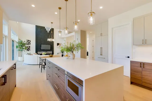 a living room with furniture a dining table and a fireplace