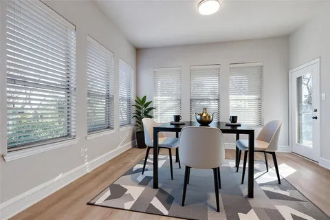 a view of a dining room with furniture window and wooden floor