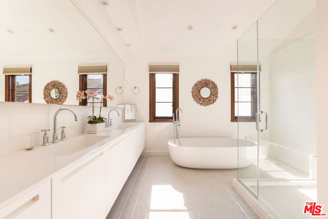 604 Alta Drive Beverly Hills, CA 90210 - Photo 11 of 21 a spacious bathroom with a double vanity sink and a mirror