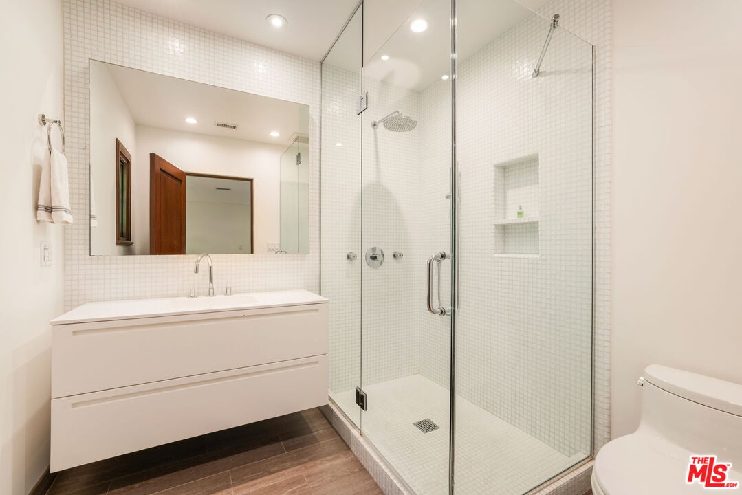 604 Alta Drive Beverly Hills, CA 90210 - Photo 15 of 21 a bathroom with a sink a toilet and shower
