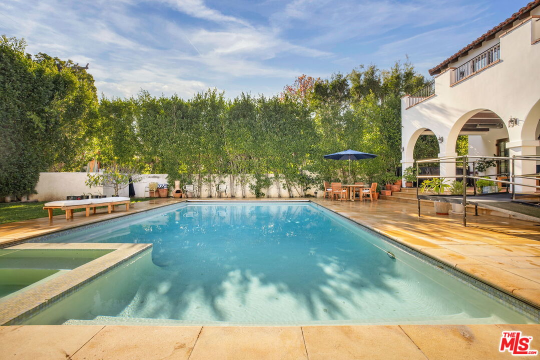 604 Alta Drive Beverly Hills, CA 90210 - Photo 16 of 21 a view of swimming pool with outdoor seating and trees in the background