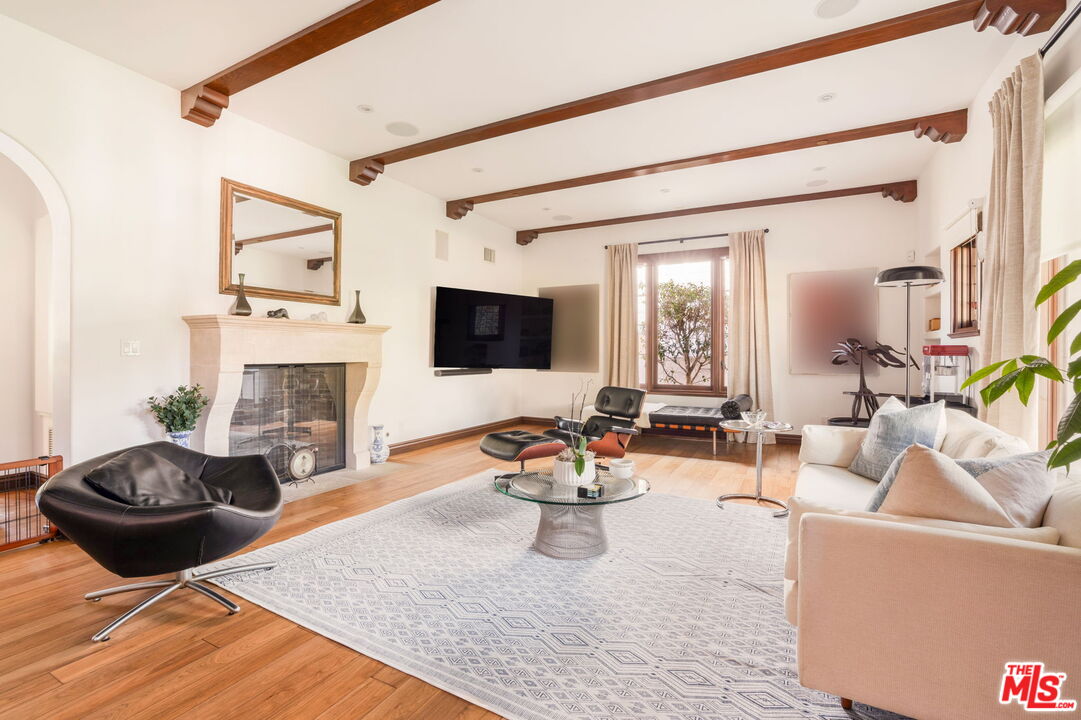 604 Alta Drive Beverly Hills, CA 90210 - Photo 4 of 21 a living room with furniture a fireplace and a flat screen tv
