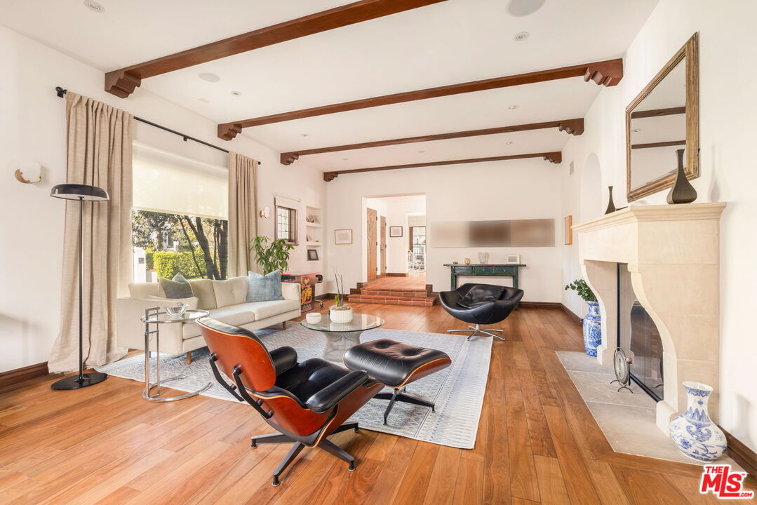 604 Alta Drive Beverly Hills, CA 90210 - Photo 5 of 21 a living room with fireplace furniture and a floor to ceiling window