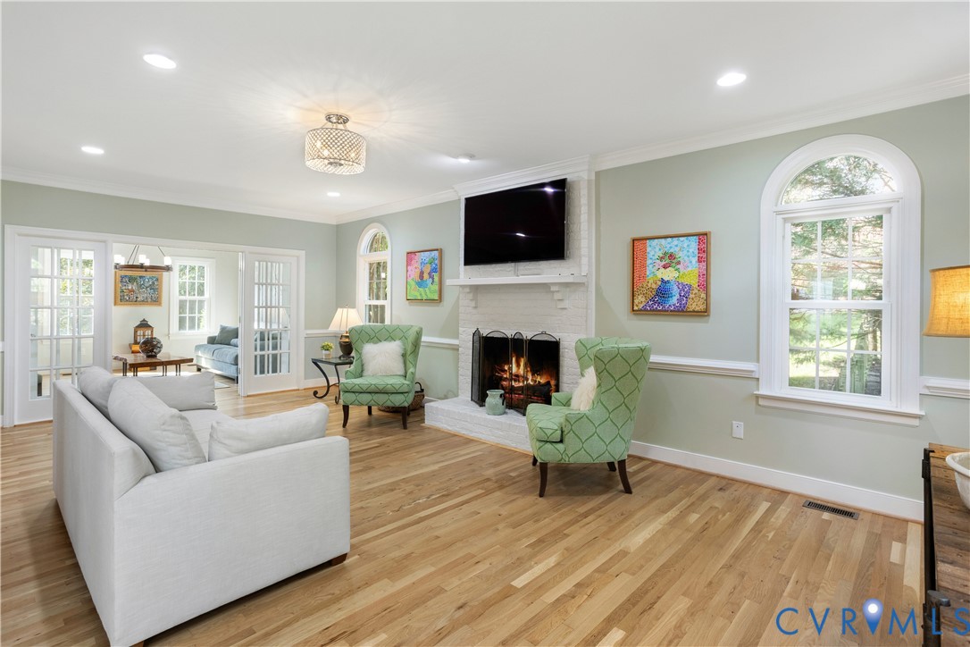 407 Lynchell Place Henrico, VA 23238 - Photo 13 of 50 a living room with furniture a fireplace and a flat screen tv
