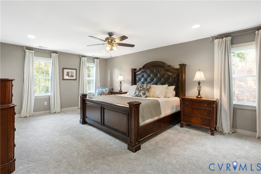 407 Lynchell Place Henrico, VA 23238 - Photo 28 of 50 a spacious bedroom with a bed and a chandelier