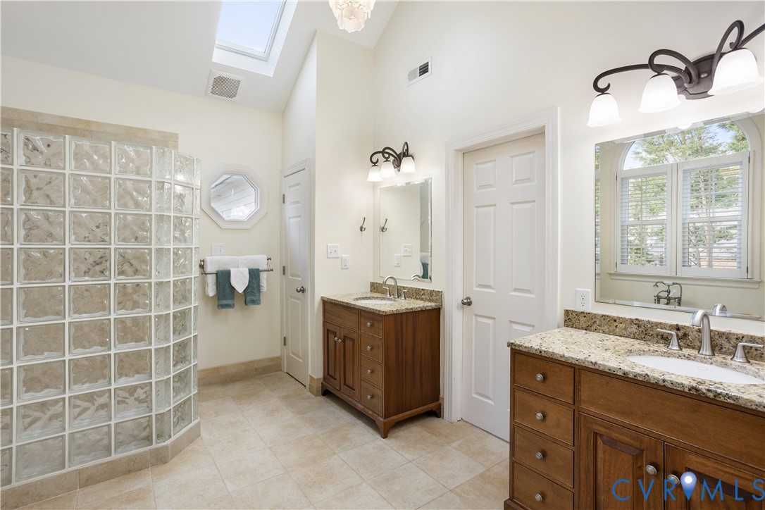 407 Lynchell Place Henrico, VA 23238 - Photo 31 of 50 a spacious bathroom with a granite countertop sink a mirror and a shower