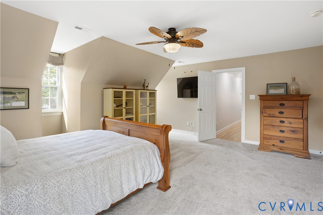 407 Lynchell Place Henrico, VA 23238 - Photo 39 of 50 a bedroom with a bed and a flat tv screen on dresser