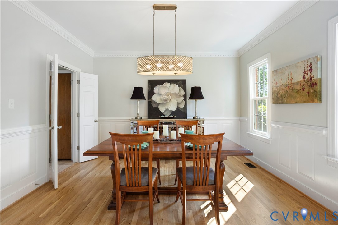 407 Lynchell Place Henrico, VA 23238 - Photo 6 of 50 a view of a dining room with furniture wooden floor and chandelier