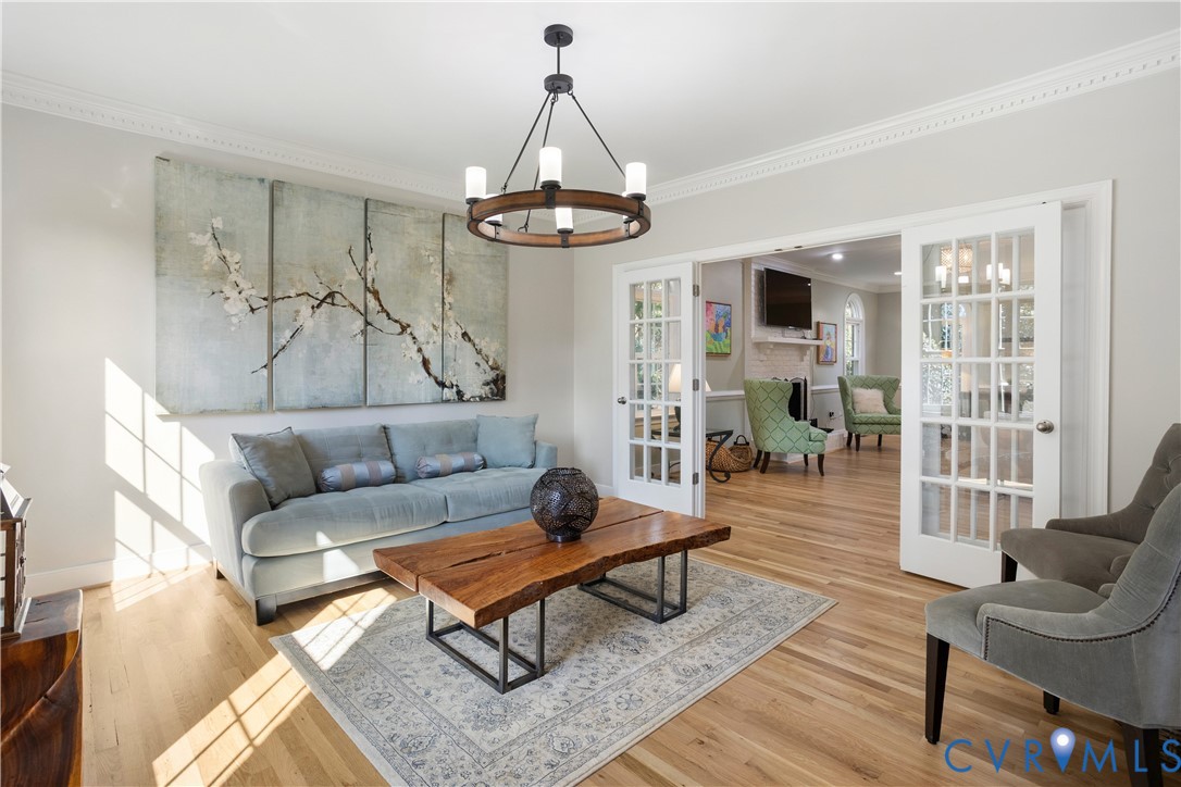407 Lynchell Place Henrico, VA 23238 - Photo 10 of 50 a living room with furniture a rug and a chandelier
