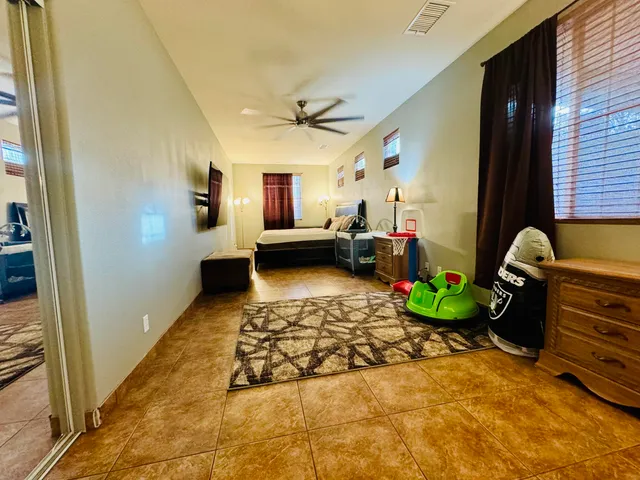 a living room with patio furniture and a flat screen tv