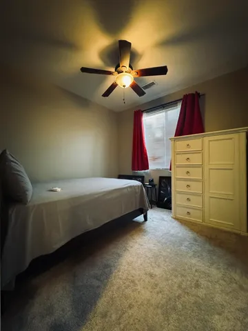 a bedroom with a bed and window
