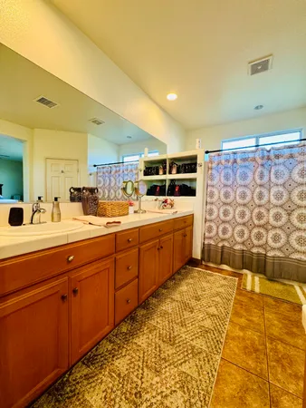 a room with stainless steel appliances kitchen island granite countertop a sink and cabinets