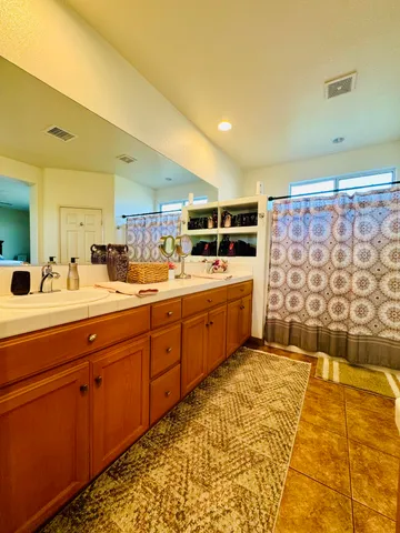 a room with stainless steel appliances kitchen island granite countertop a sink and cabinets