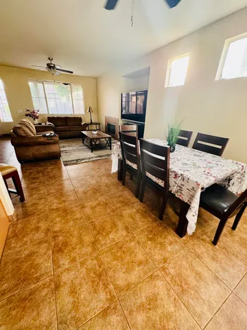 a living room with furniture stove and kitchen view