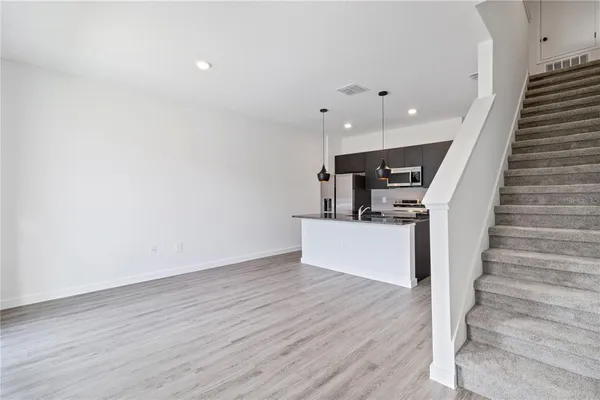 a view of entryway and hall with wooden floor