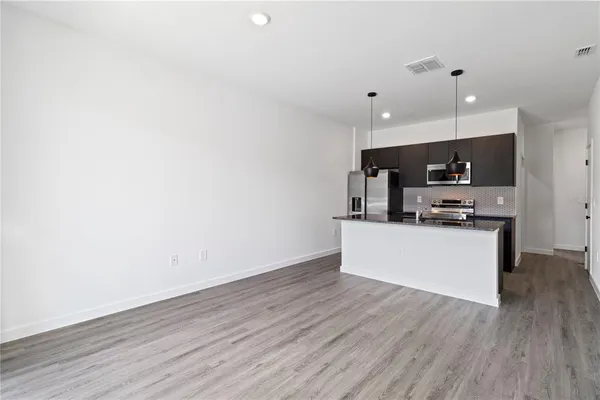 a kitchen with stainless steel appliances a refrigerator and a stove top oven