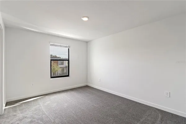 an empty room with windows and closet