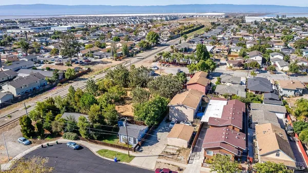 an aerial view of a residential houses with outdoor space and street view