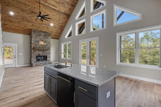 a kitchen with granite countertop a sink and a stove