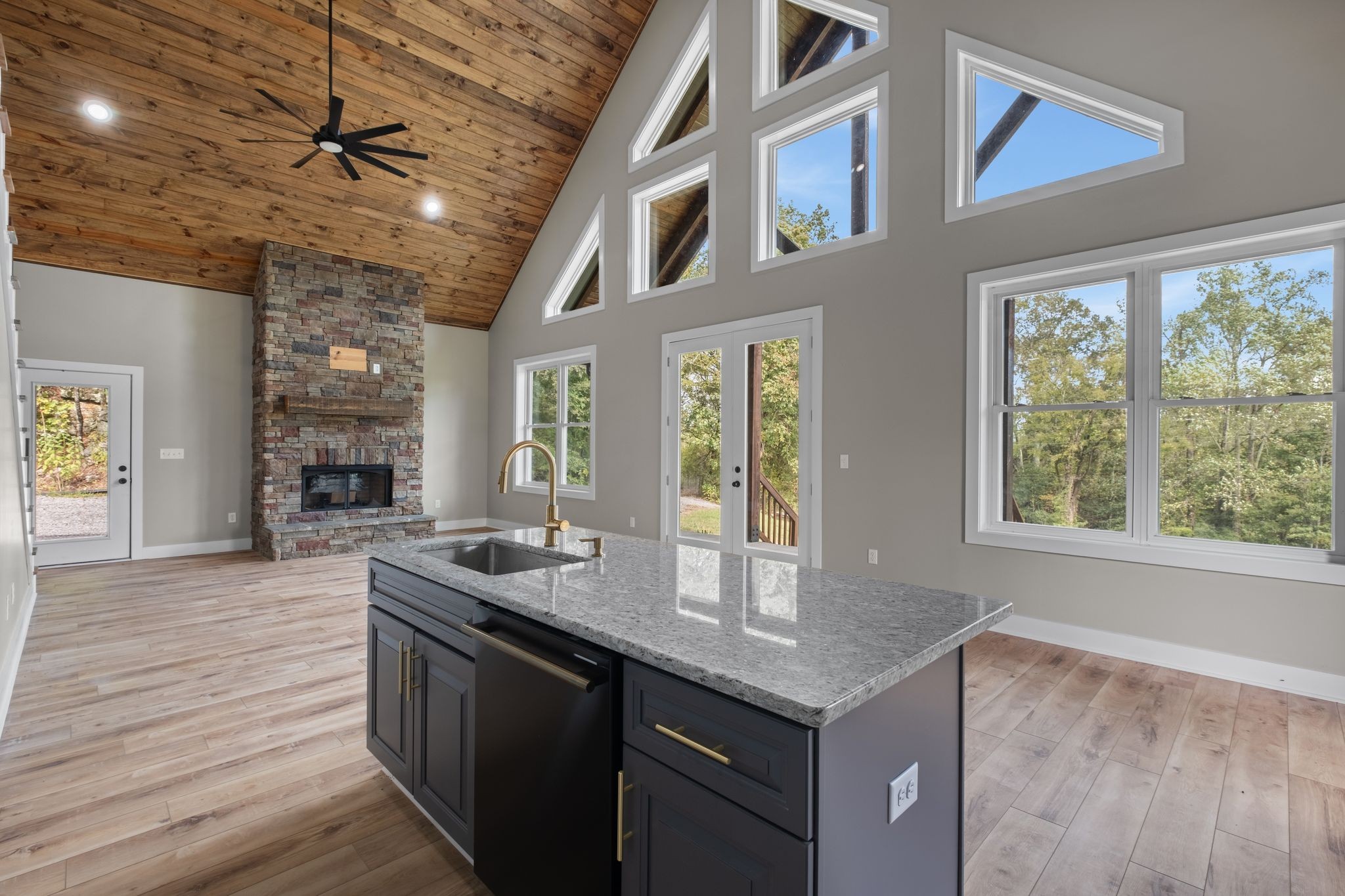 a kitchen with granite countertop a sink and a stove